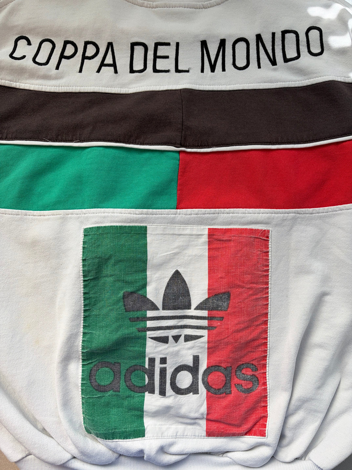  and red color-blocked stripes and a large Adidas trefoil logo with 'Coppa del Mondo' text on the back