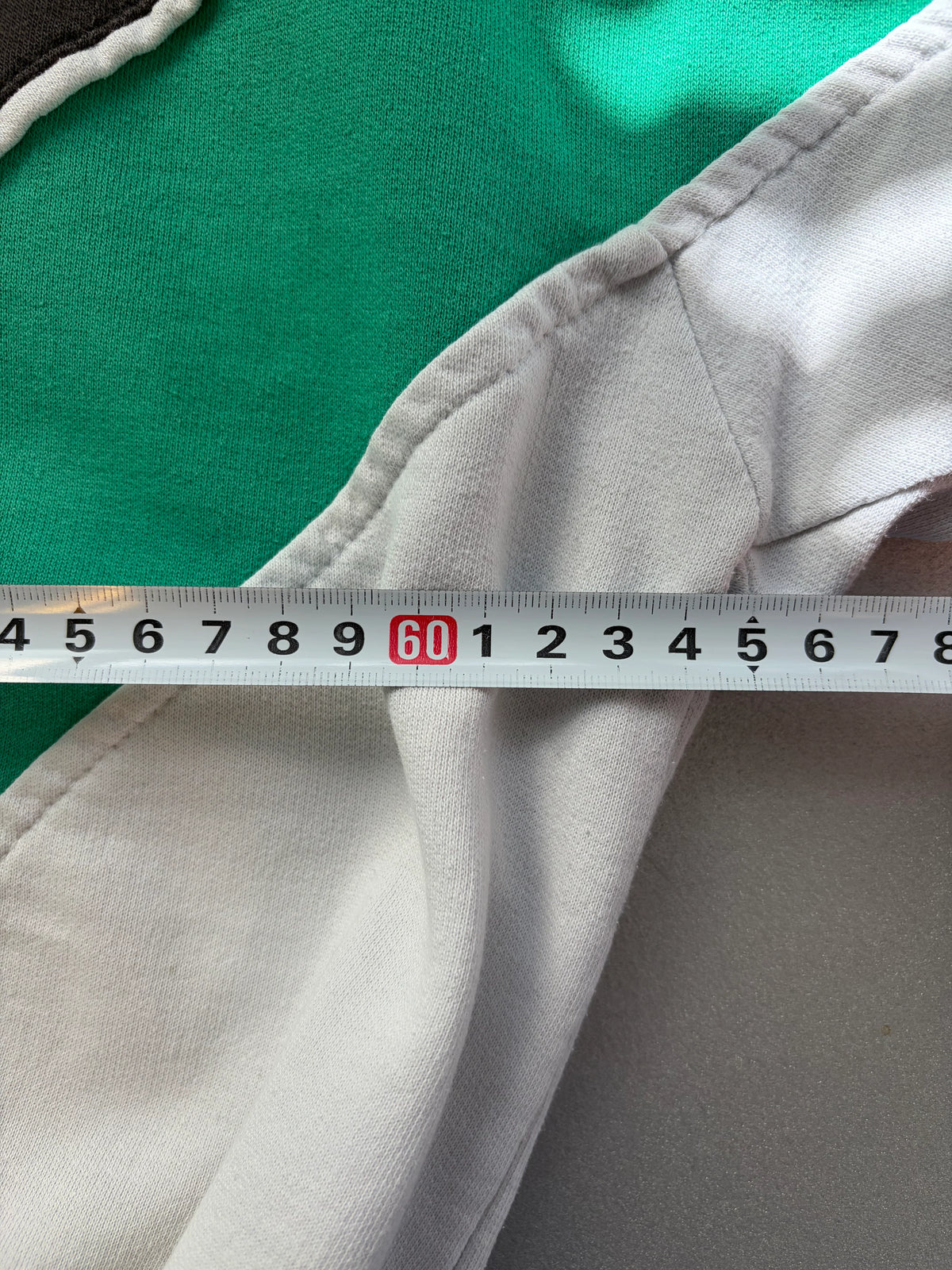  and green color-blocked design with 'ITALIA' printed across the chest and a white stylized lion graphic in the center.