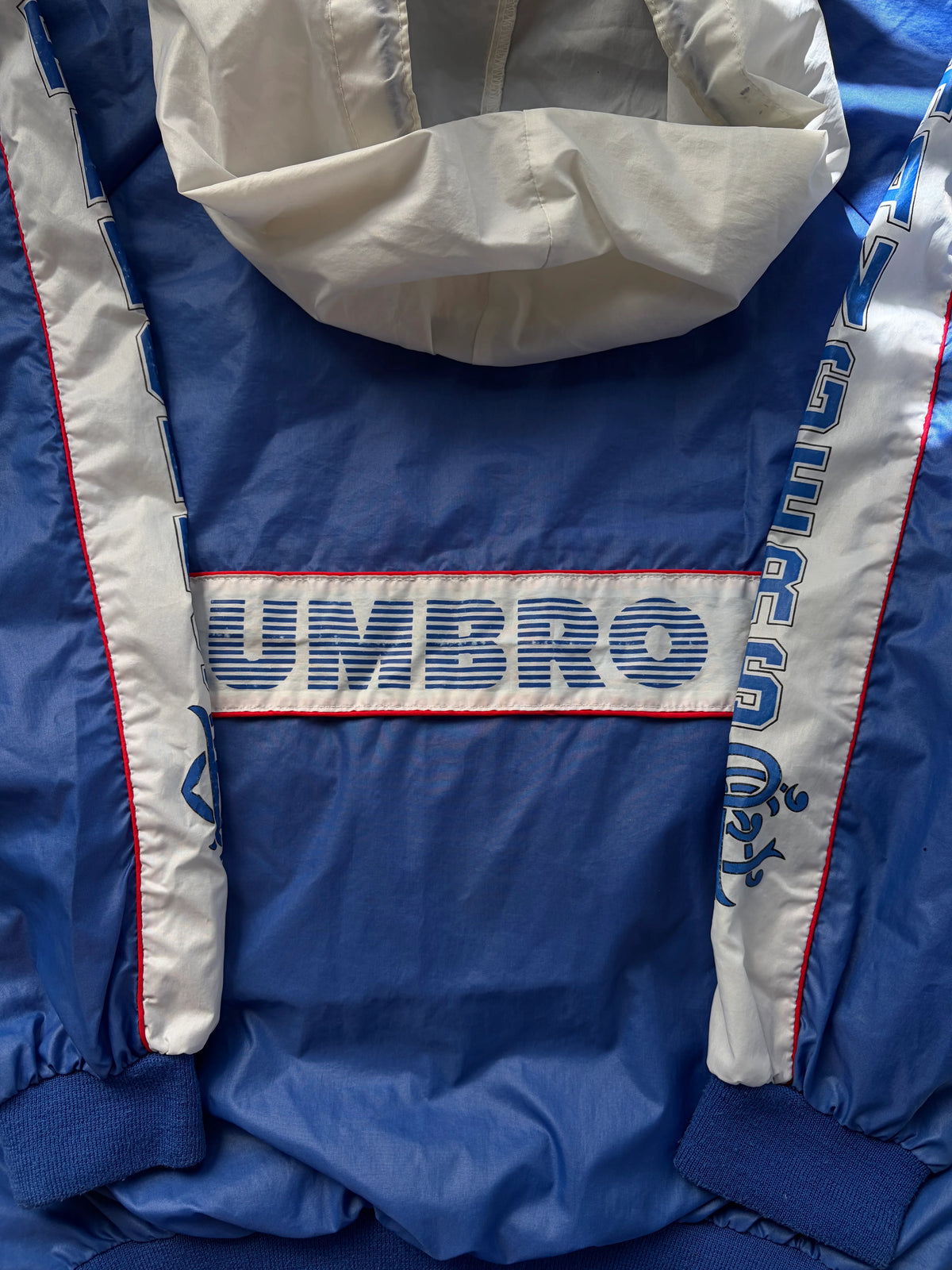  and white sleeves with blue text.