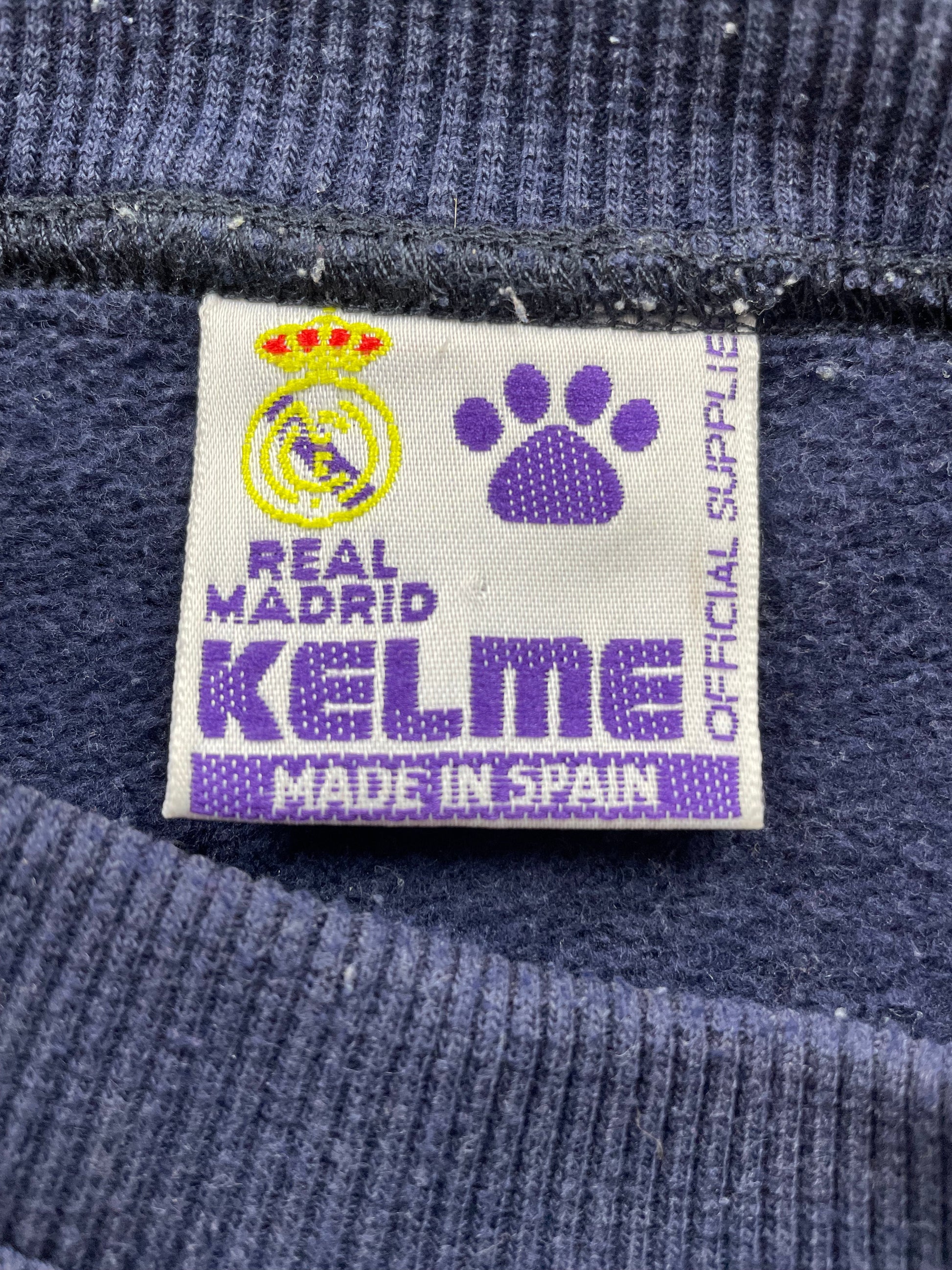  displayed on a wooden dress form. The brand name 'KELME' is printed in white on the back collar.
