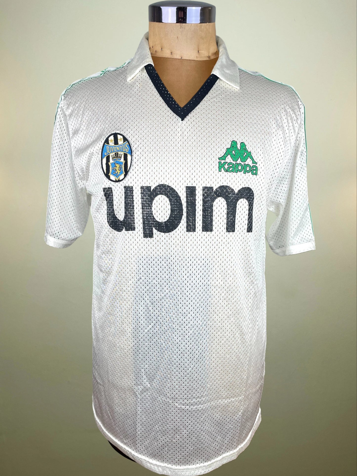 A vintage white Kappa soccer jersey with black trim and the 'upim' logo