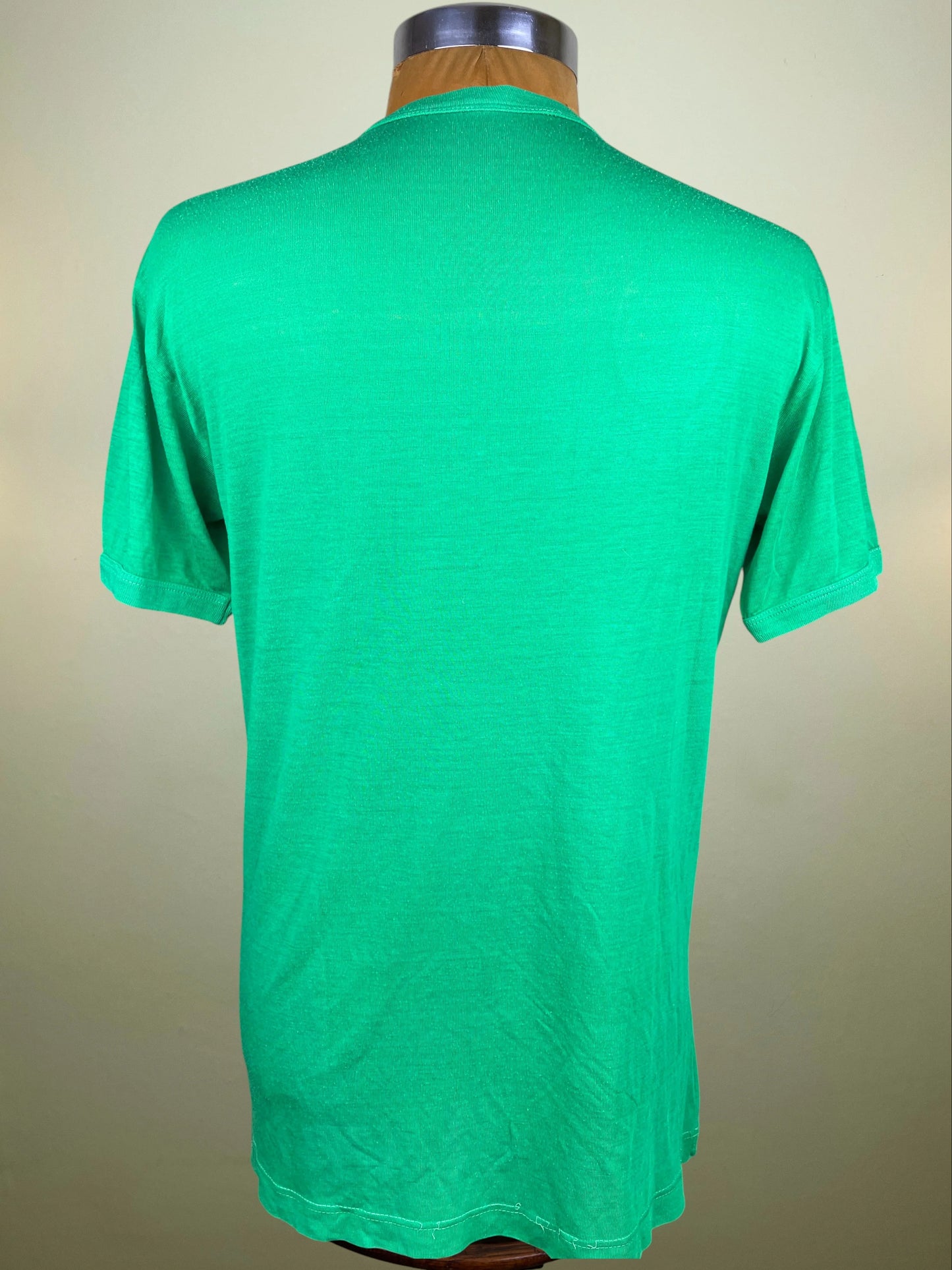  displayed on a wooden mannequin torso. The jersey features a V-neck