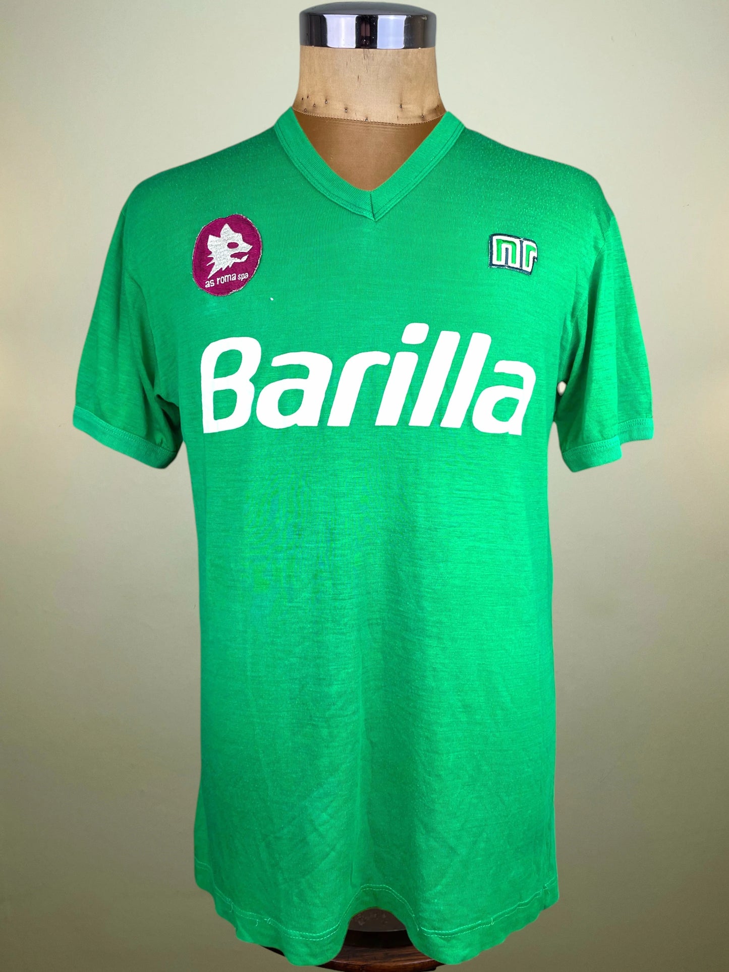 A green vintage Roma jersey with 'Barilla' printed in white across the chest