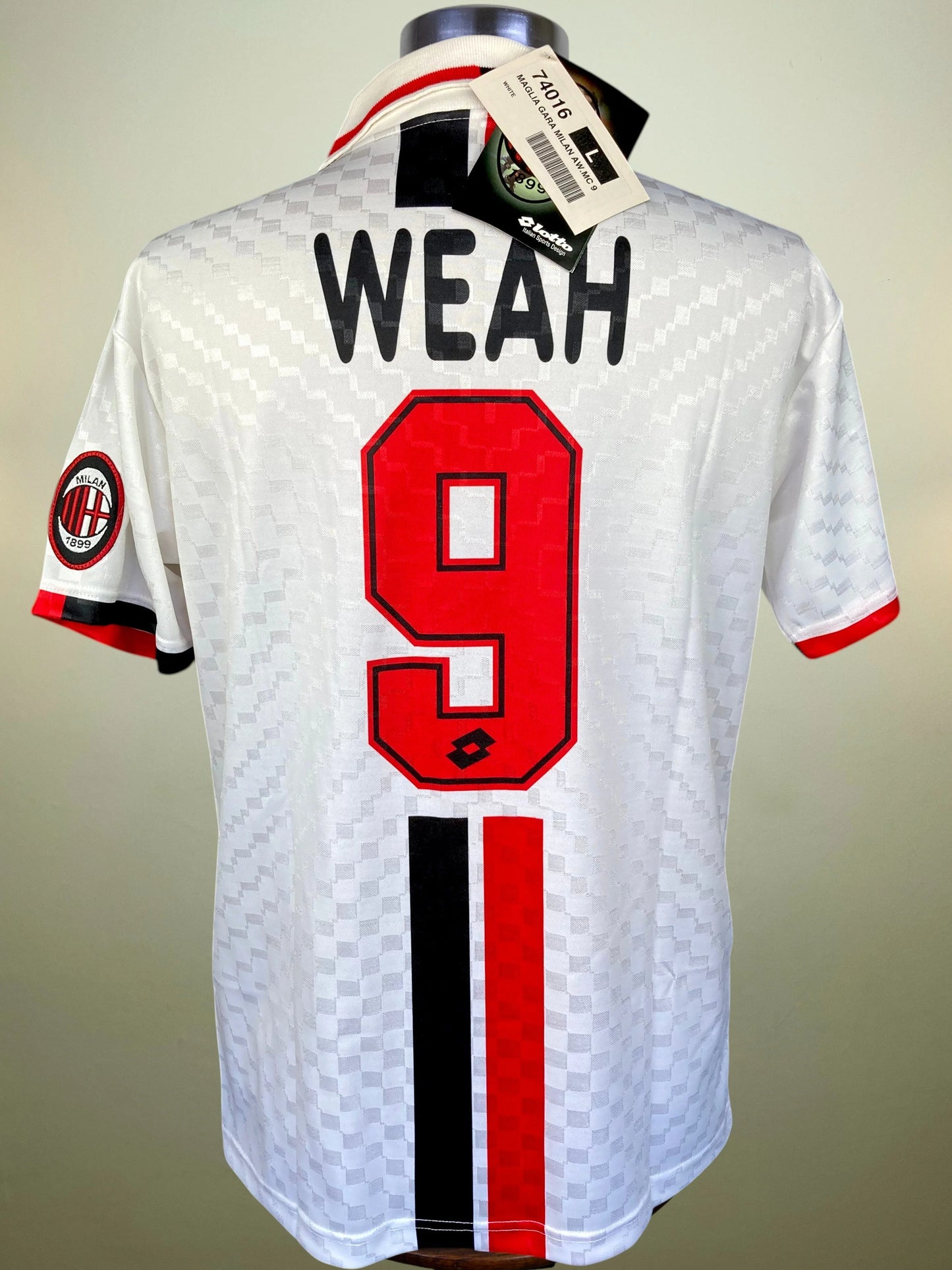 White AC Milan soccer jersey with 'WEAH' and number 9 on the back