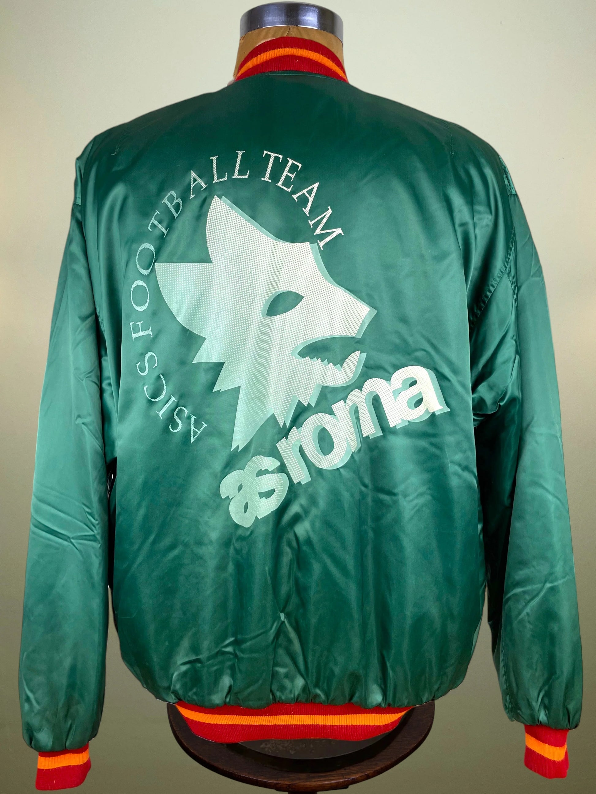 Green satin bomber jacket shown from the back on a mannequin