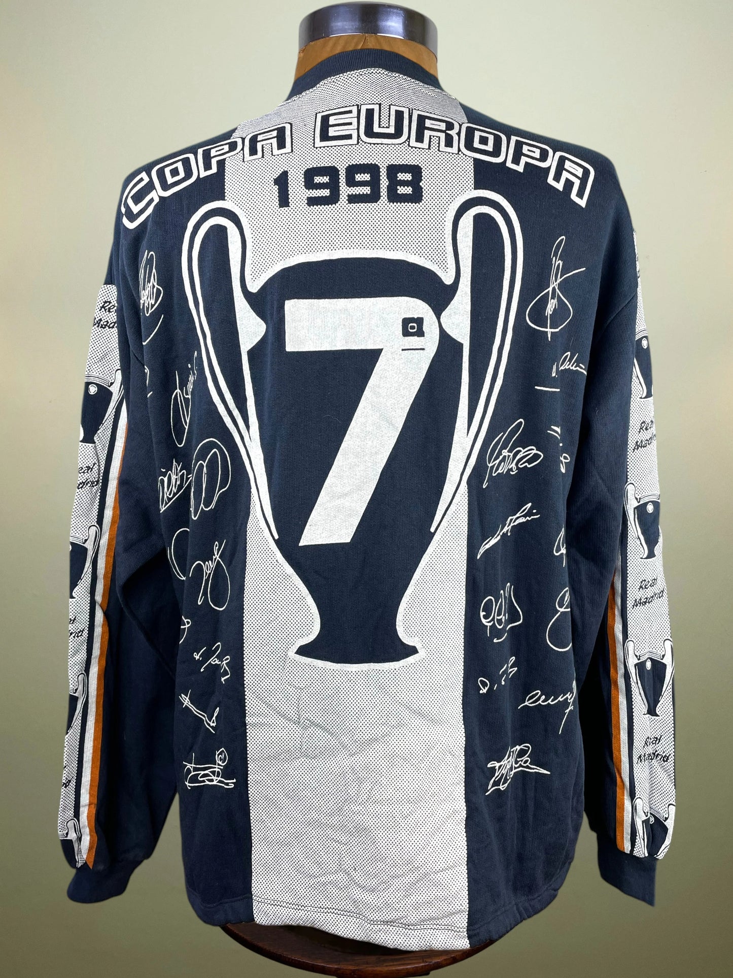 A long-sleeve navy and white soccer jersey displayed on a mannequin