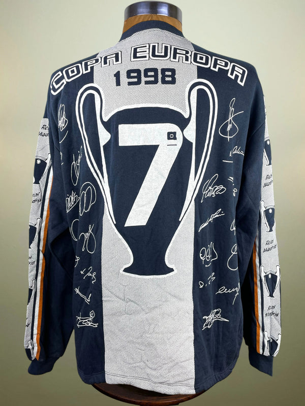 A long-sleeve navy and white soccer jersey displayed on a mannequin